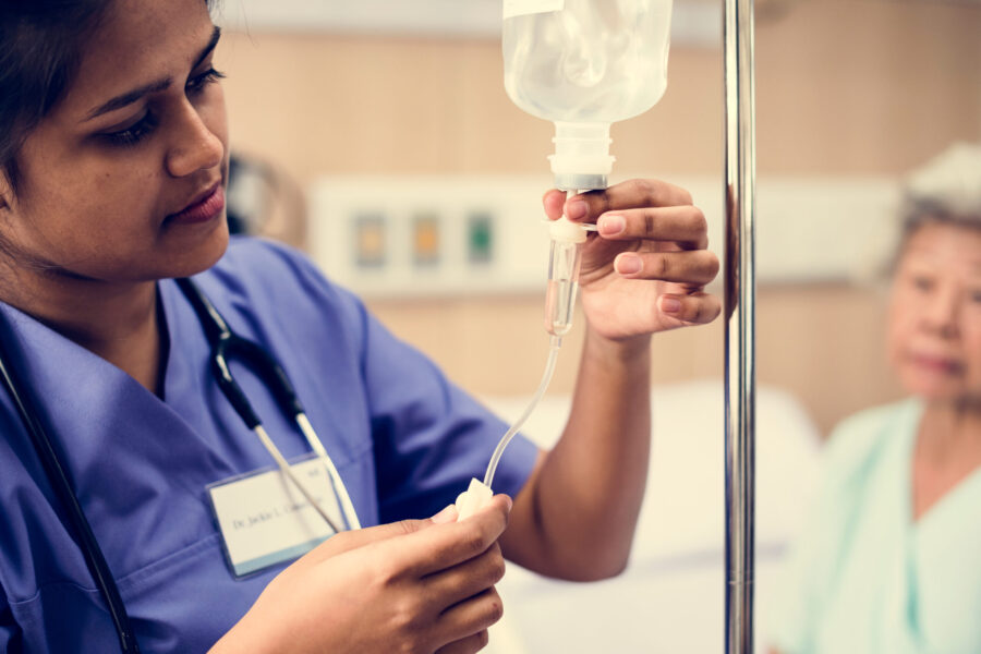 Close up of a doctor checking an IV bag
