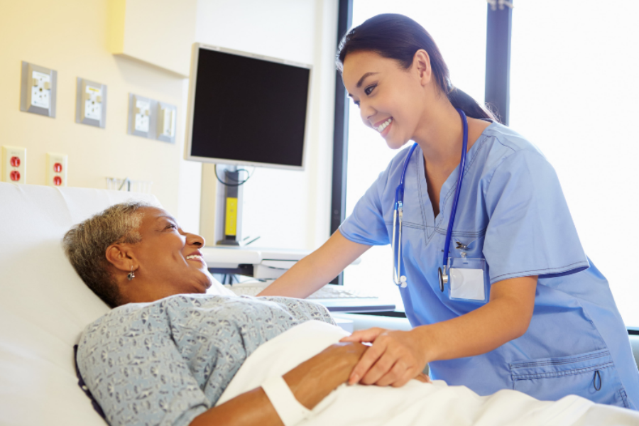 Doctor checking on a patient in a hospital bed