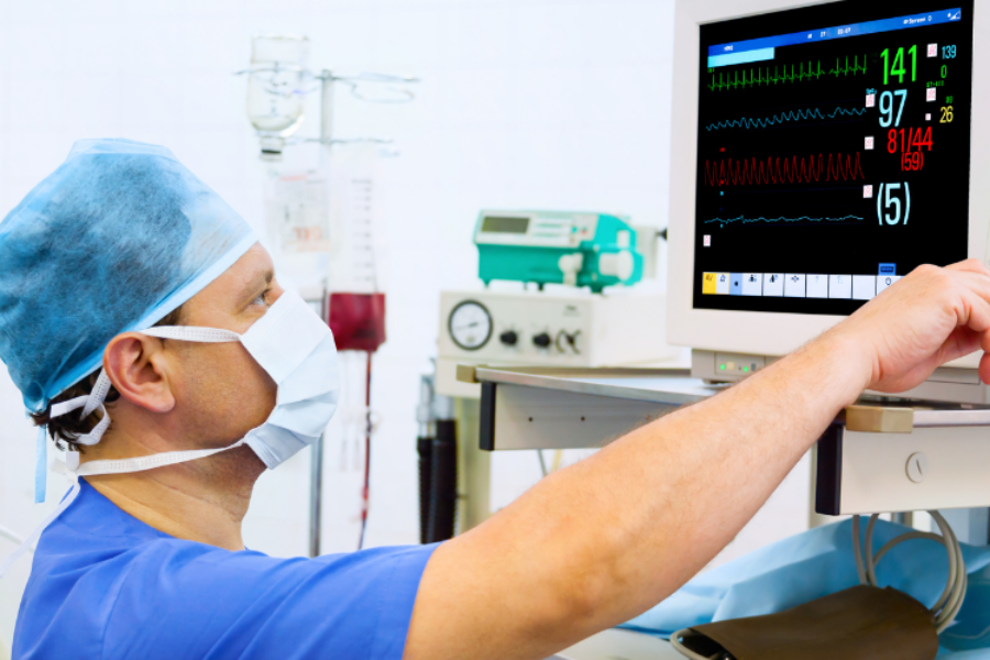 Close up of doctor reading a heart rate monitor during surgery